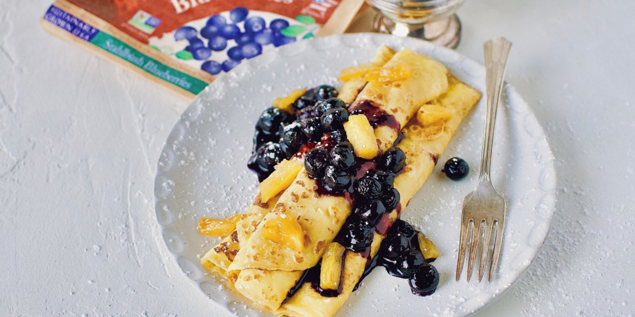 https://thesweetpotato.ca/wp-content/uploads/2022/02/Crepes-with-Caramelized-Pineapple-and-Blueberries4-scaled-1-1280x640.jpeg